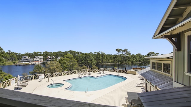 317 Turtle Cv, Panama City Beach, FL 32413 - view of pool with a water view, a patio, and a hot tub