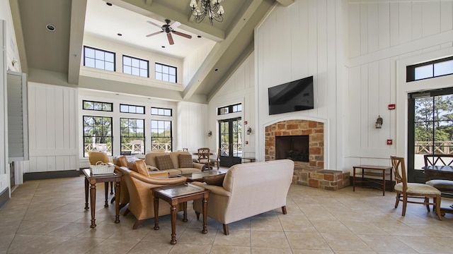 317 Turtle Cv, Panama City Beach, FL 32413 - living area featuring a fireplace, light tile patterned floors, a high ceiling, and ceiling fan