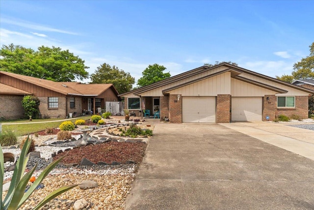 view of front of home featuring concrete driveway, brick siding, and a garage