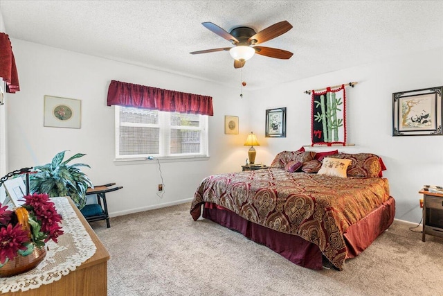 bedroom featuring baseboards, ceiling fan, carpet, and a textured ceiling