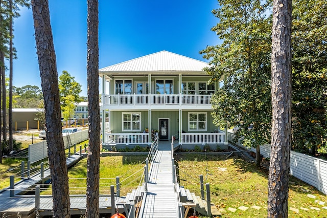 1158 Mack Bayou Rd, Santa Rosa Beach, FL 32459 - view of front of property with covered porch, stairway, metal roof, fence, and a balcony