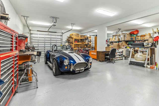 1158 Mack Bayou Rd, Santa Rosa Beach, FL 32459 - garage featuring a garage door opener and a workshop area