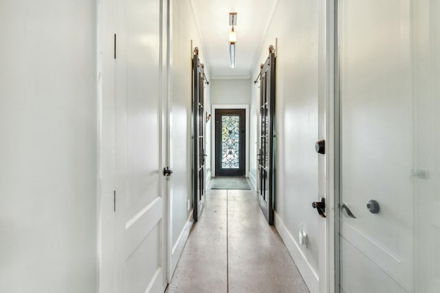 1158 Mack Bayou Rd, Santa Rosa Beach, FL 32459 - hall featuring crown molding, concrete flooring, baseboards, and a barn door