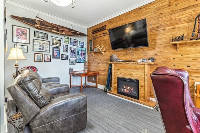 1158 Mack Bayou Rd, Santa Rosa Beach, FL 32459 - living room featuring baseboards, crown molding, wood finished floors, wood walls, and a glass covered fireplace