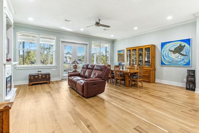 1158 Mack Bayou Rd, Santa Rosa Beach, FL 32459 - living room featuring a wealth of natural light, a ceiling fan, ornamental molding, light wood finished floors, and baseboards