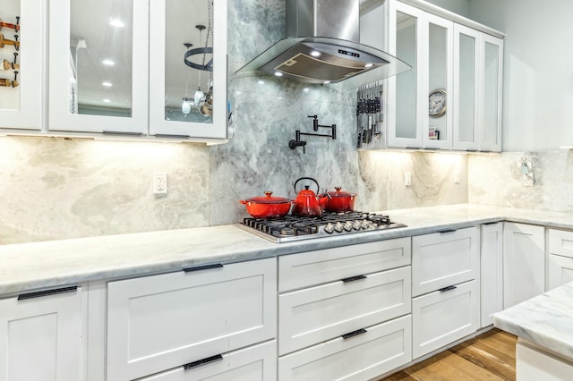 1158 Mack Bayou Rd, Santa Rosa Beach, FL 32459 - kitchen featuring extractor fan, white cabinetry, light stone counters, and decorative backsplash