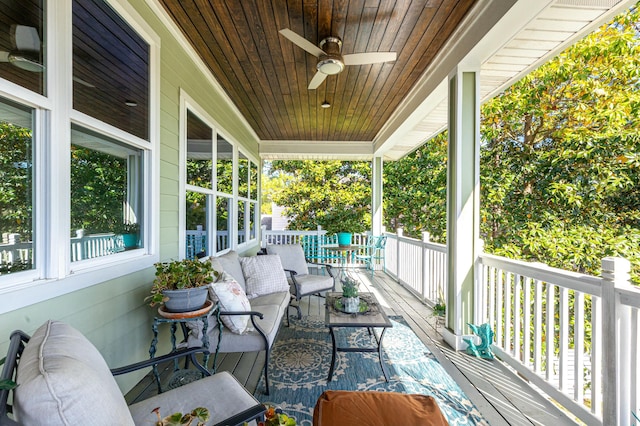 1158 Mack Bayou Rd, Santa Rosa Beach, FL 32459 - wooden deck with outdoor lounge area, ceiling fan, and covered porch