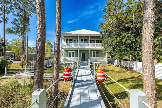 1158 Mack Bayou Rd, Santa Rosa Beach, FL 32459 - view of front of home featuring fence, metal roof, and a balcony