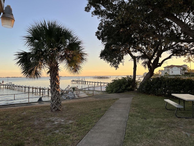 view of home's community featuring a yard and a water view