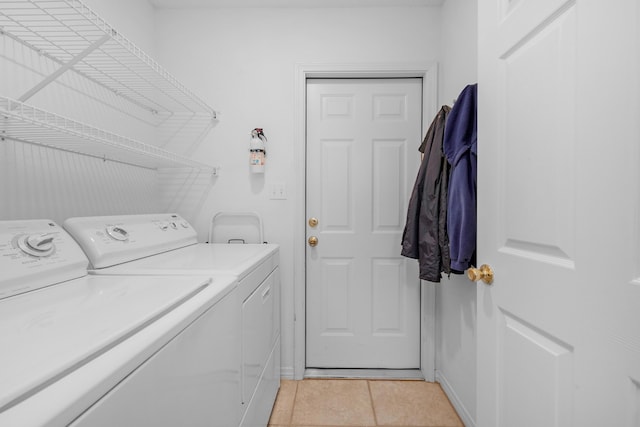 washroom featuring independent washer and dryer, laundry area, and light tile patterned floors