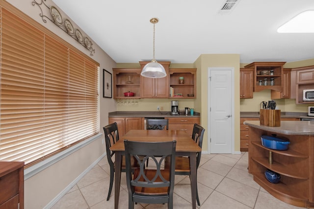 dining room with light tile patterned floors, baseboards, and visible vents