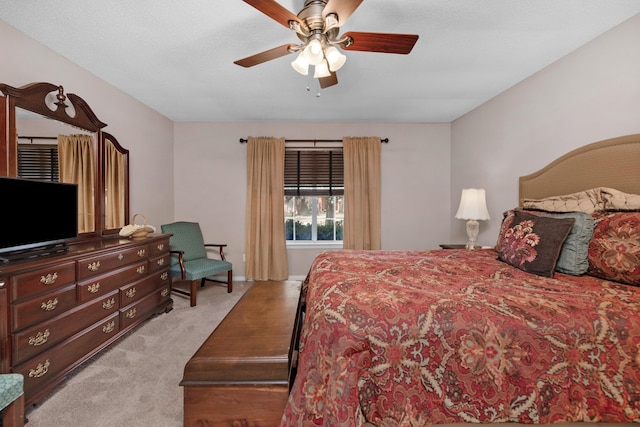 bedroom featuring light carpet, ceiling fan, and baseboards