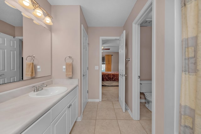 bathroom with ensuite bathroom, vanity, tile patterned flooring, visible vents, and toilet