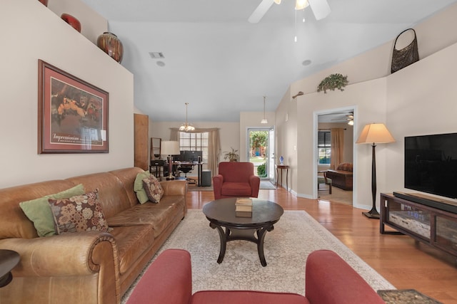 living room with visible vents, a ceiling fan, vaulted ceiling, and wood finished floors