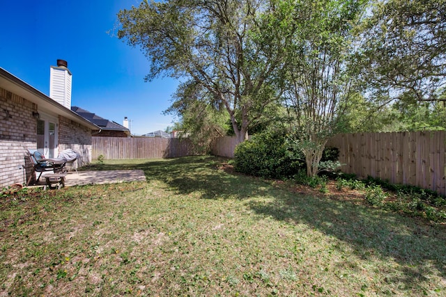 view of yard featuring a fenced backyard and a patio area