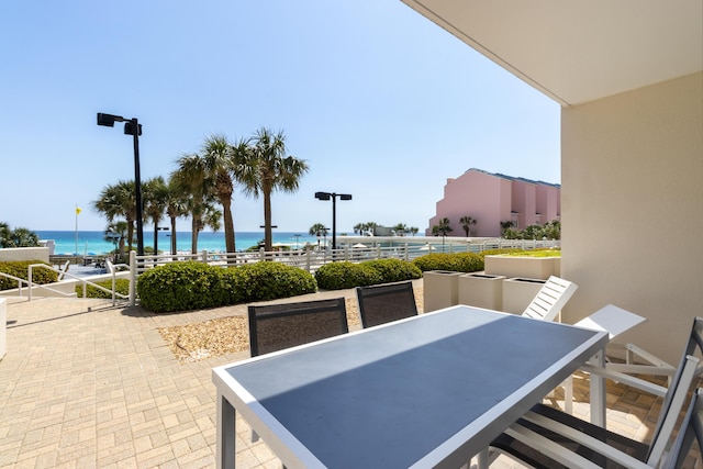 view of patio with outdoor dining space and a water view