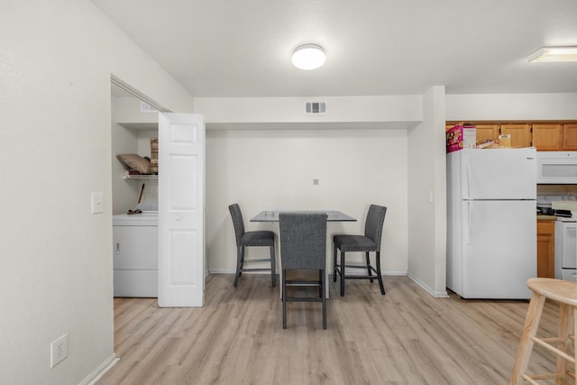 4010 Dancing Cloud Ct Unit 391, Destin, FL 32541 - dining space featuring washer / clothes dryer, light wood-style flooring, and baseboards