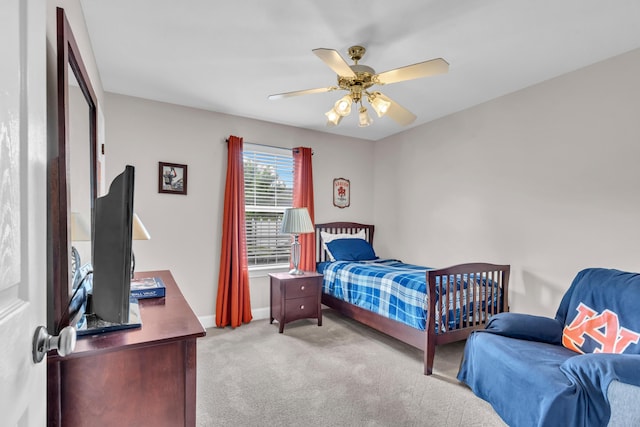 bedroom featuring baseboards, a ceiling fan, and carpet