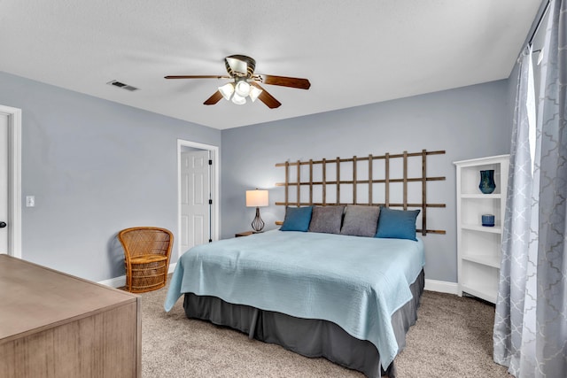 carpeted bedroom featuring a ceiling fan, baseboards, and visible vents