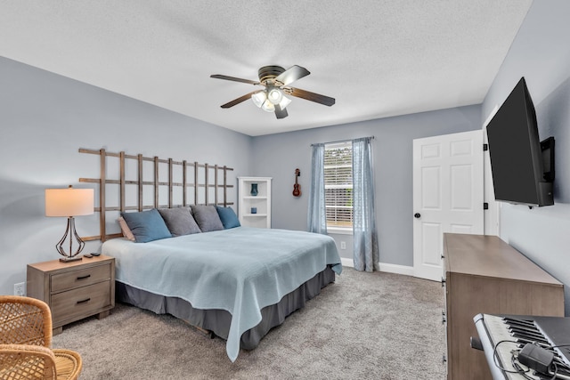 bedroom with baseboards, light carpet, a ceiling fan, and a textured ceiling