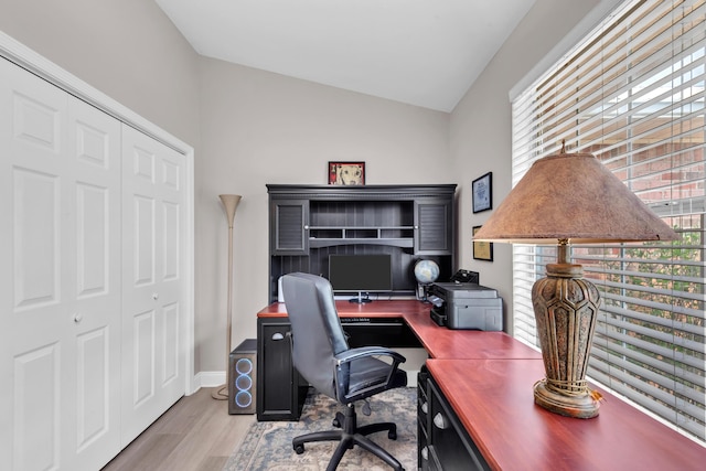 home office featuring baseboards, vaulted ceiling, and wood finished floors
