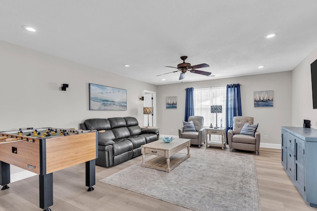 living room with recessed lighting, a ceiling fan, and light wood-style flooring