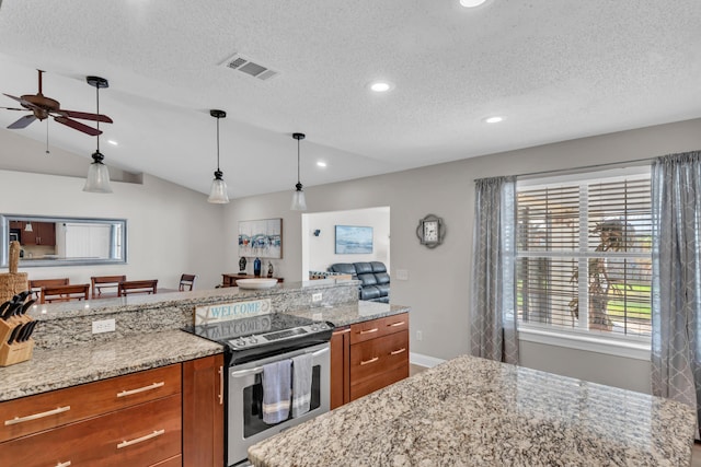 kitchen with stainless steel electric stove, a ceiling fan, brown cabinets, and visible vents