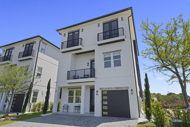 80 Sea Croft Dr, Santa Rosa Beach, FL 32459 - contemporary home featuring decorative driveway, a garage, a balcony, and stucco siding