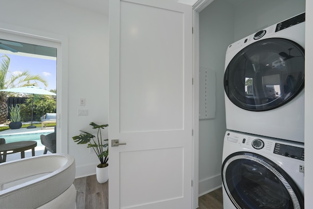 80 Sea Croft Dr, Santa Rosa Beach, FL 32459 - laundry area with laundry area, stacked washer and clothes dryer, baseboards, and wood finished floors