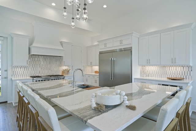 80 Sea Croft Dr, Santa Rosa Beach, FL 32459 - kitchen featuring white cabinetry, built in fridge, custom exhaust hood, and tasteful backsplash