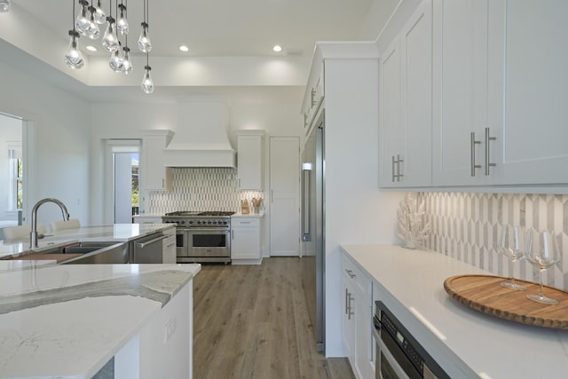 80 Sea Croft Dr, Santa Rosa Beach, FL 32459 - kitchen featuring decorative backsplash, custom range hood, a sink, stainless steel appliances, and white cabinetry