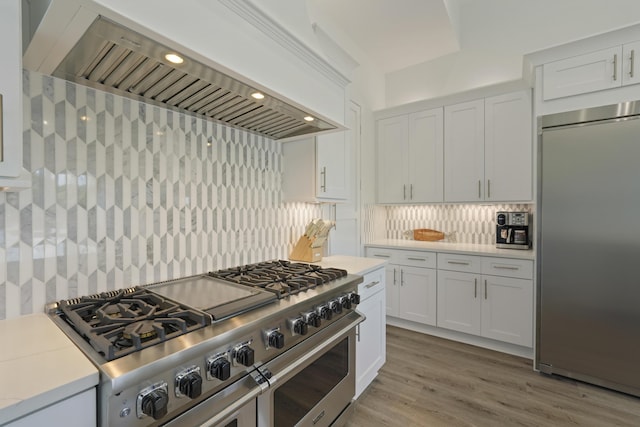 80 Sea Croft Dr, Santa Rosa Beach, FL 32459 - kitchen featuring white cabinets, high quality appliances, extractor fan, and decorative backsplash