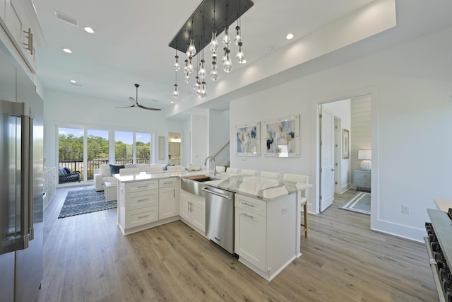 80 Sea Croft Dr, Santa Rosa Beach, FL 32459 - kitchen with visible vents, open floor plan, light wood-type flooring, and stainless steel appliances