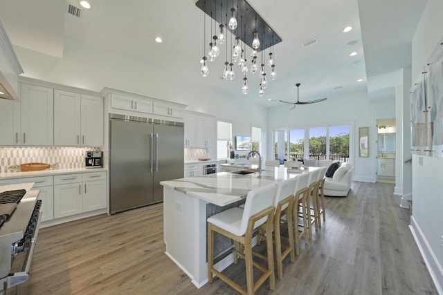 80 Sea Croft Dr, Santa Rosa Beach, FL 32459 - kitchen with white cabinets, a sink, backsplash, premium appliances, and visible vents