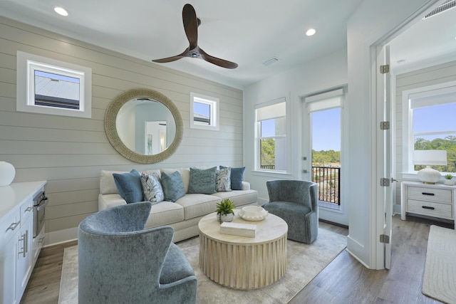 80 Sea Croft Dr, Santa Rosa Beach, FL 32459 - living room with ceiling fan, wood walls, visible vents, and wood finished floors