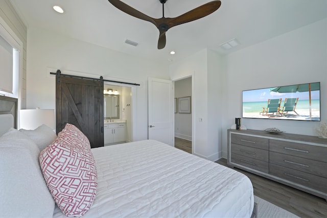 80 Sea Croft Dr, Santa Rosa Beach, FL 32459 - bedroom with wood finished floors, recessed lighting, a barn door, and visible vents