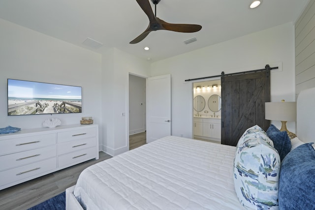 80 Sea Croft Dr, Santa Rosa Beach, FL 32459 - bedroom with recessed lighting, visible vents, a barn door, and wood finished floors