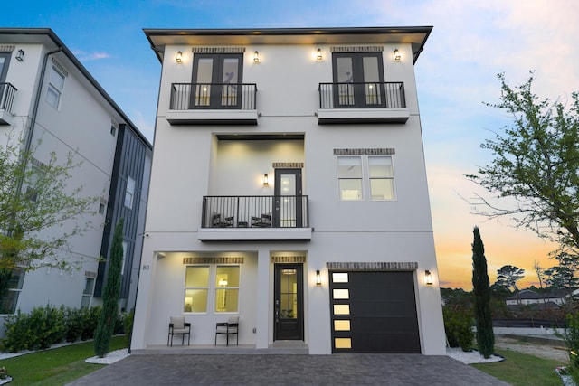 80 Sea Croft Dr, Santa Rosa Beach, FL 32459 - back of property with a garage, decorative driveway, stucco siding, and a balcony
