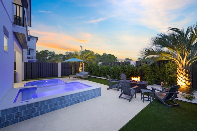 80 Sea Croft Dr, Santa Rosa Beach, FL 32459 - pool at dusk featuring a fenced backyard, an in ground hot tub, a fire pit, and a patio area