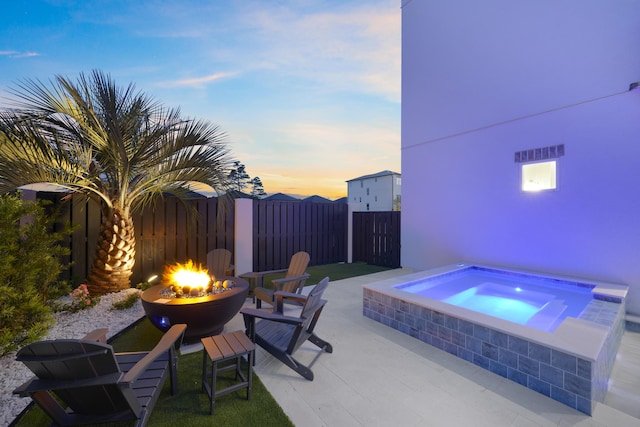 80 Sea Croft Dr, Santa Rosa Beach, FL 32459 - patio terrace at dusk with an in ground hot tub, fence, and an outdoor fire pit