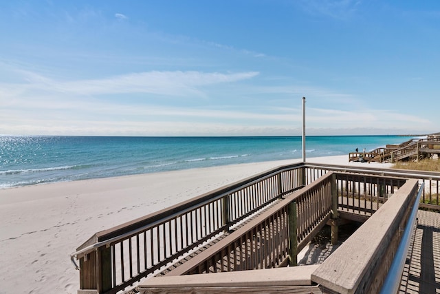 view of property's community featuring a water view and a view of the beach