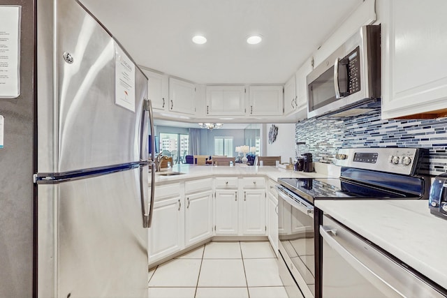 kitchen with white cabinetry, light countertops, appliances with stainless steel finishes, and light tile patterned flooring