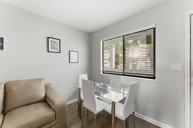 dining room featuring baseboards and wood finished floors