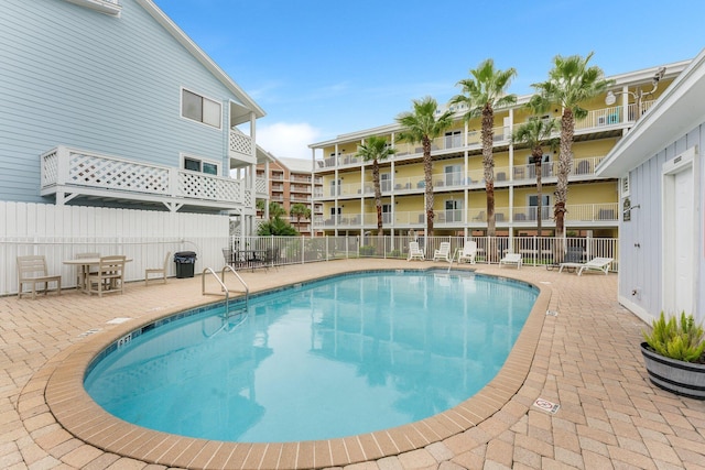 pool featuring a patio and fence