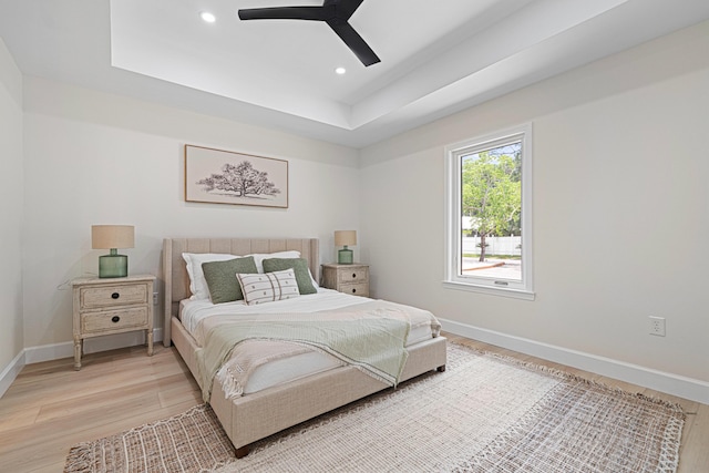 34 Debbie Ln, Santa Rosa Beach, FL 32459 - bedroom with light wood-type flooring, baseboards, recessed lighting, a raised ceiling, and ceiling fan