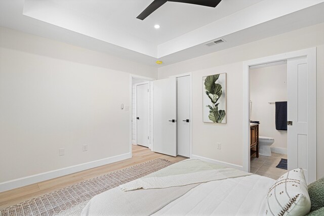 34 Debbie Ln, Santa Rosa Beach, FL 32459 - bedroom with baseboards, light wood finished floors, recessed lighting, connected bathroom, and a raised ceiling