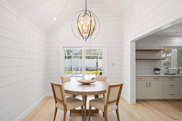 34 Debbie Ln, Santa Rosa Beach, FL 32459 - dining space with lofted ceiling, light wood finished floors, and a chandelier