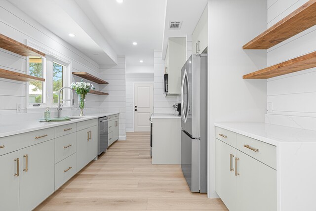 34 Debbie Ln, Santa Rosa Beach, FL 32459 - kitchen with open shelves, stainless steel appliances, recessed lighting, light wood-style flooring, and light countertops