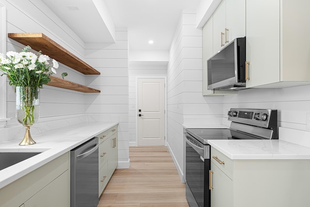 34 Debbie Ln, Santa Rosa Beach, FL 32459 - kitchen with appliances with stainless steel finishes, open shelves, light wood finished floors, recessed lighting, and light stone counters
