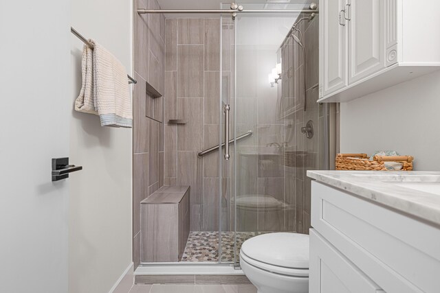 34 Debbie Ln, Santa Rosa Beach, FL 32459 - full bath with toilet, vanity, a shower stall, and tile patterned floors